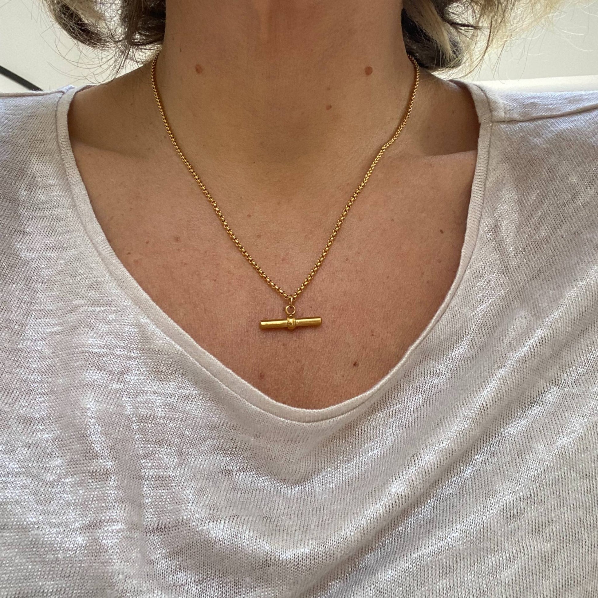 Model wearing the Gold T Bar Chain Necklace by Scott-Samuel, showcasing its elegant design
