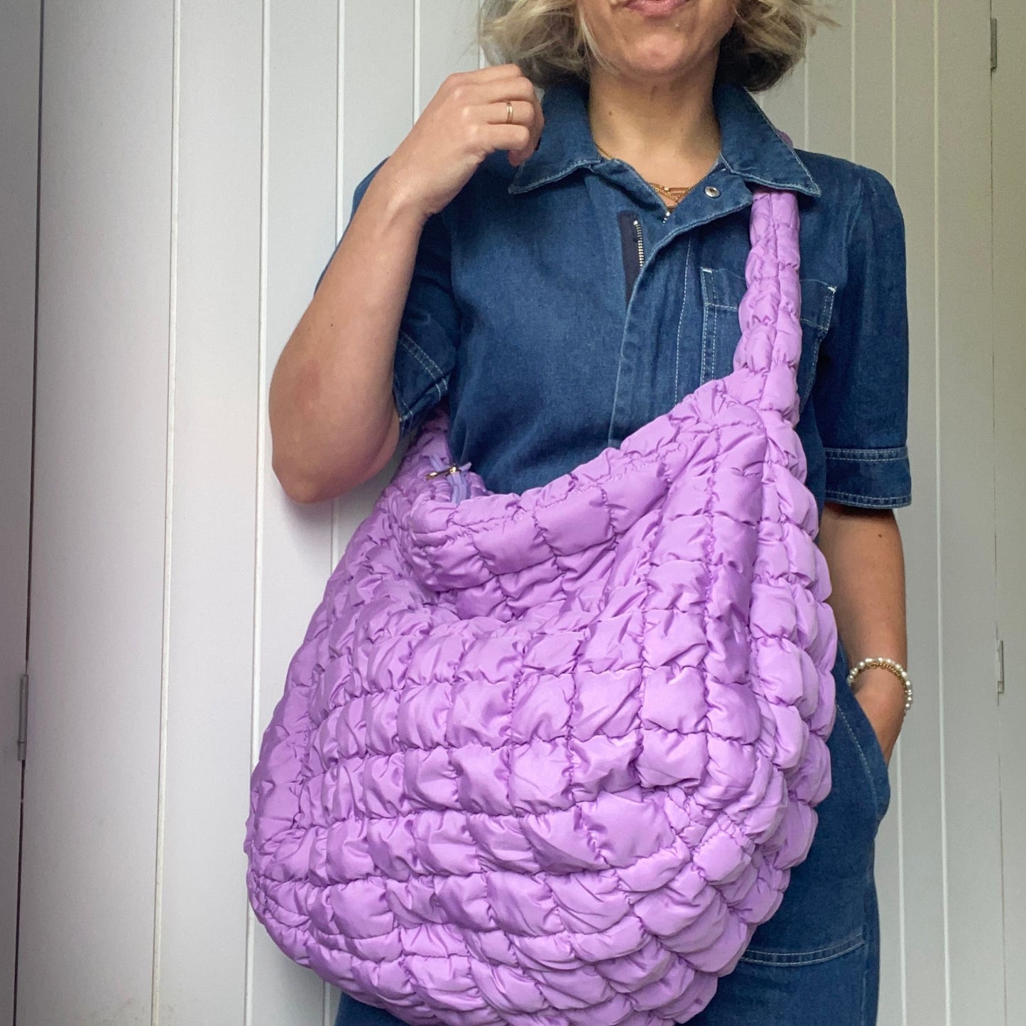 Quilted bag with adjustable strap, ideal for cross-body or shoulder wear.