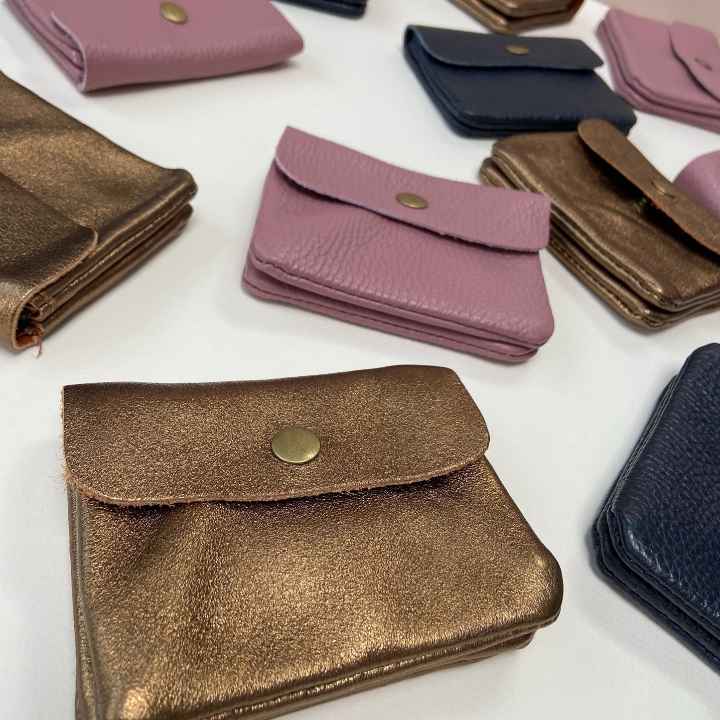 Assorted small leather purses in various colours