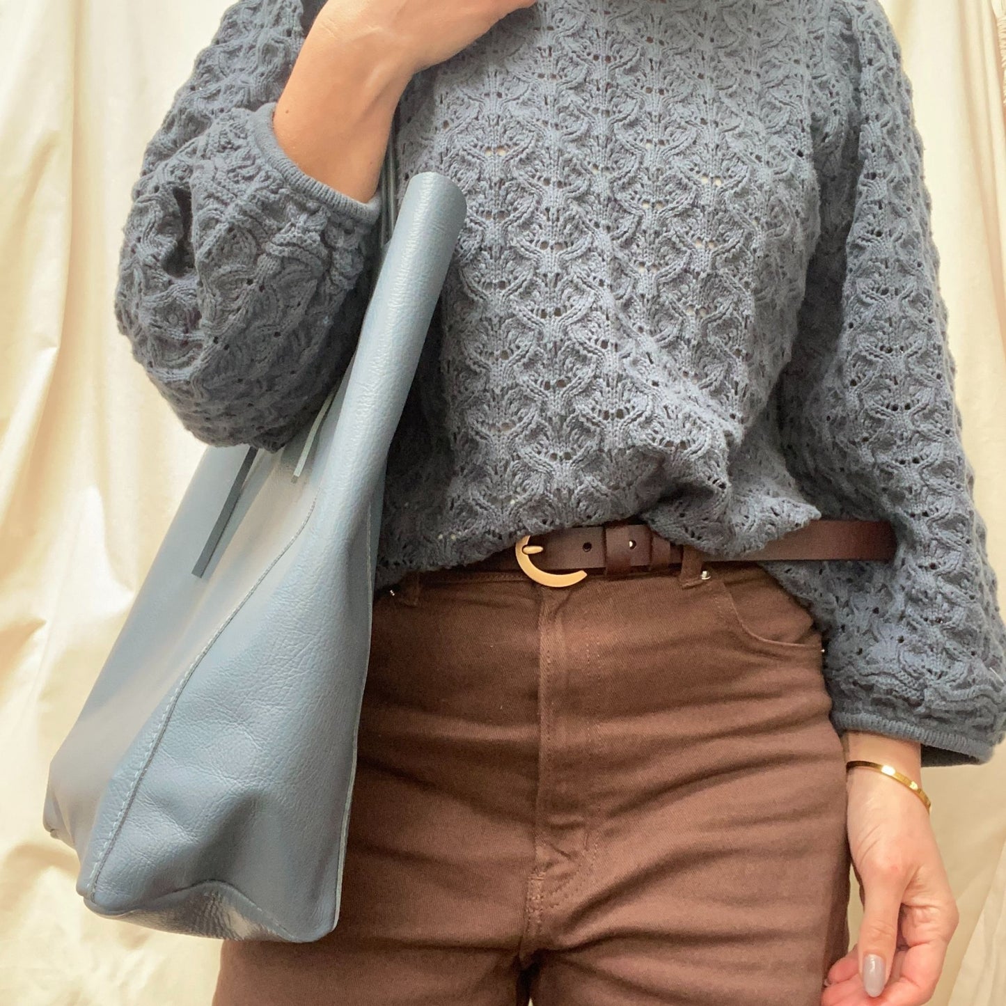 Lady holding Blue leather shopper bag