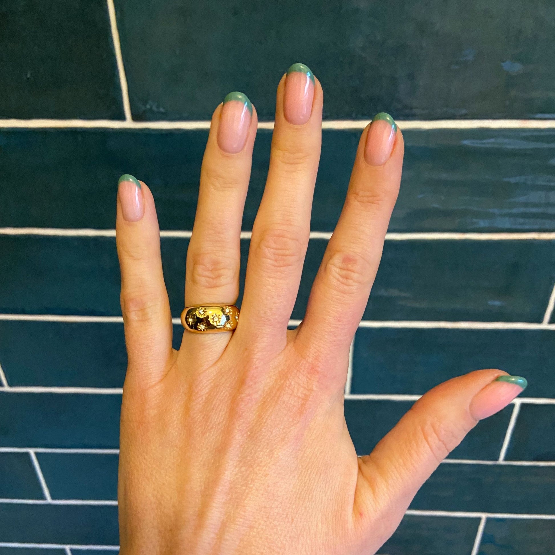 Hand wearing the Gold Domed Star Ring, showcasing its design and fit.