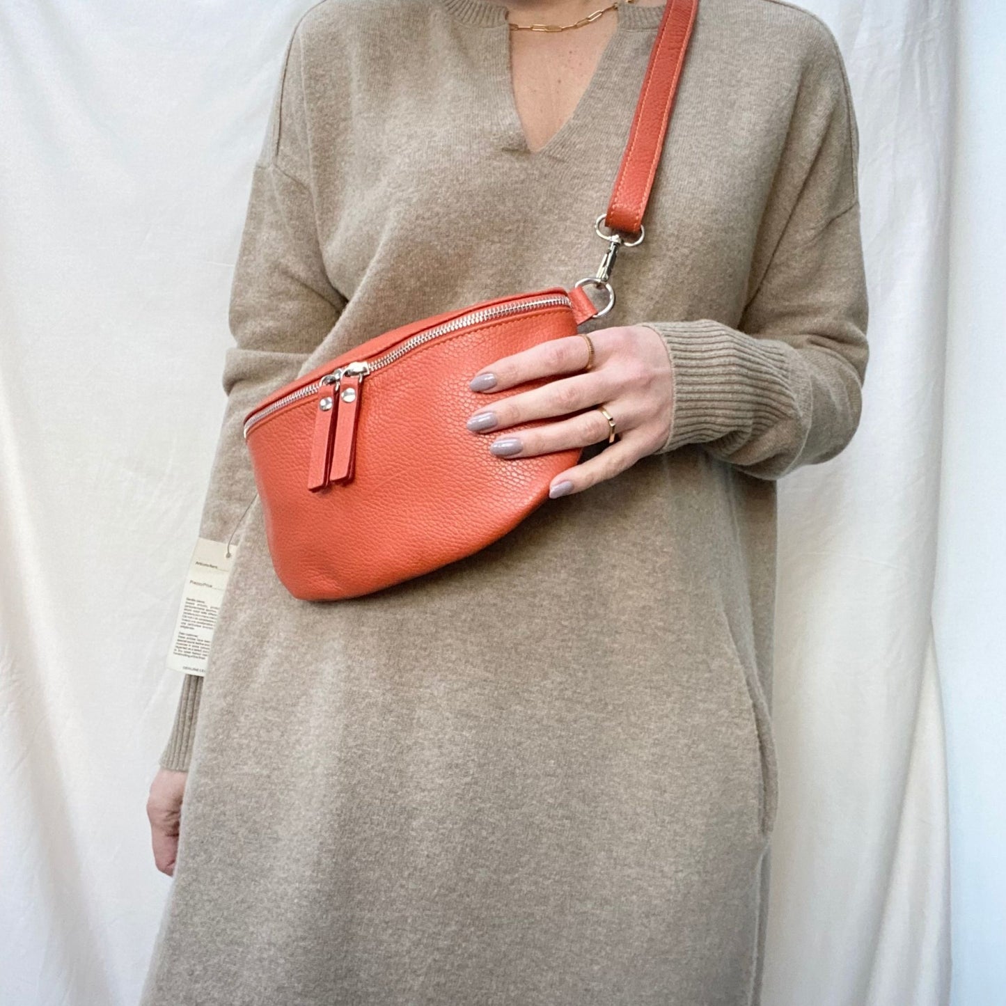 orange leather bumbag on woman