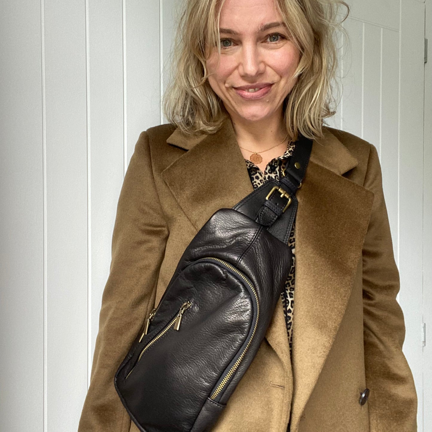 Close-up of multiple zips and pockets on the Scott-Samuel Utility Leather Cross Body Bag
