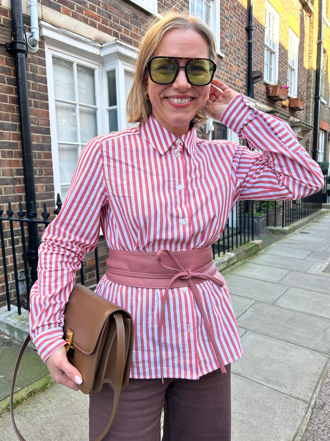 lady wearing a striped shirt and pink obi belt