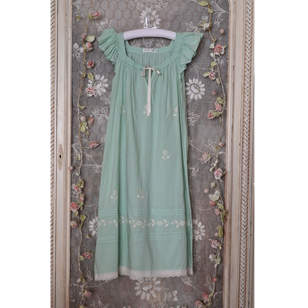 Green Vintage Style Sundress/Nightdress hanging on a decorative background.
