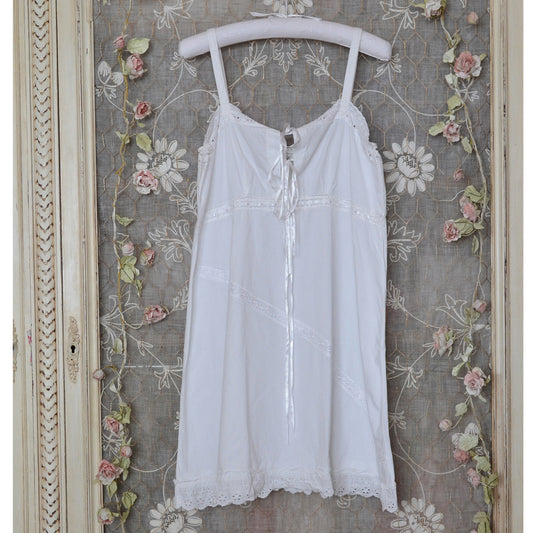 Vintage Style Broderie Anglaise White Sundress/Nightdress hanging on a decorative background