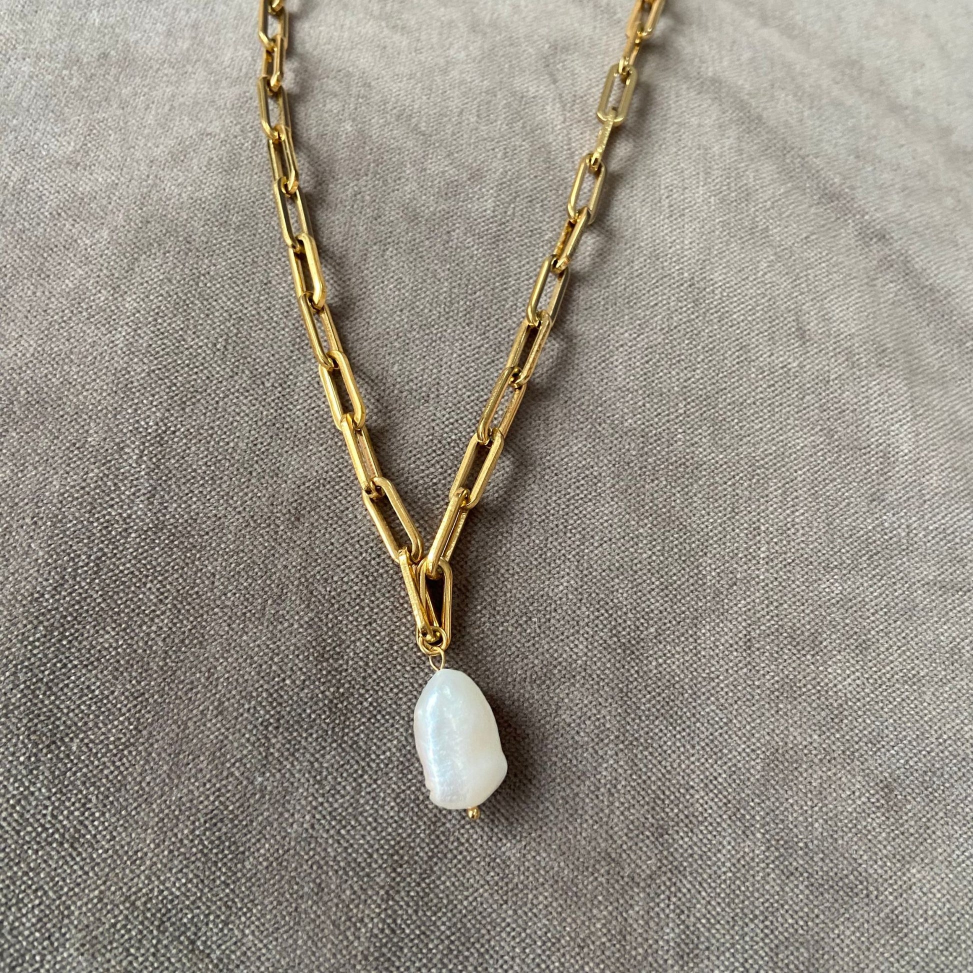 Gold chain necklace with a Freshwater Baroque Pearl pendant displayed.