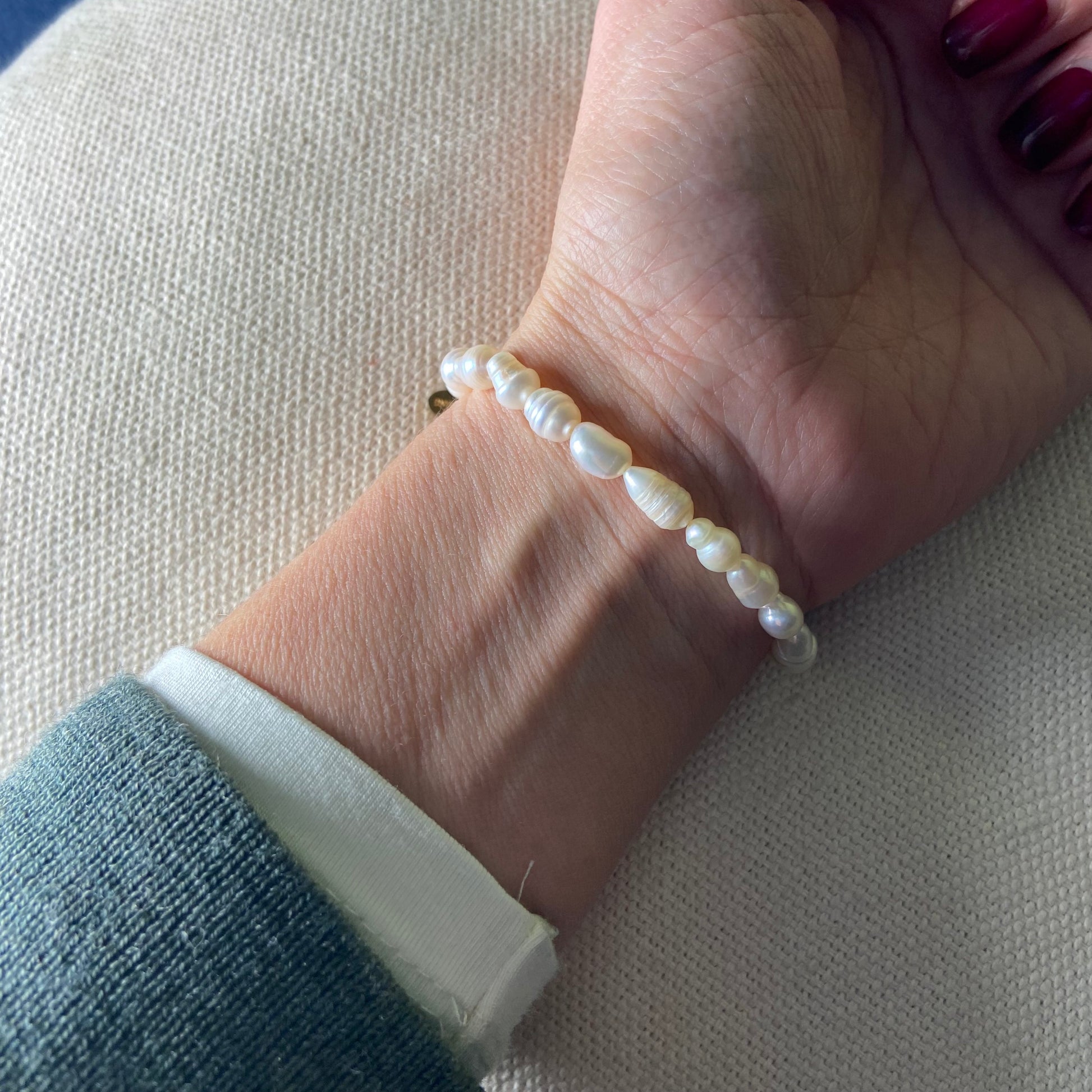 Model wearing the Freshwater Pearl Bracelet, showing its elegant fit on the wrist.