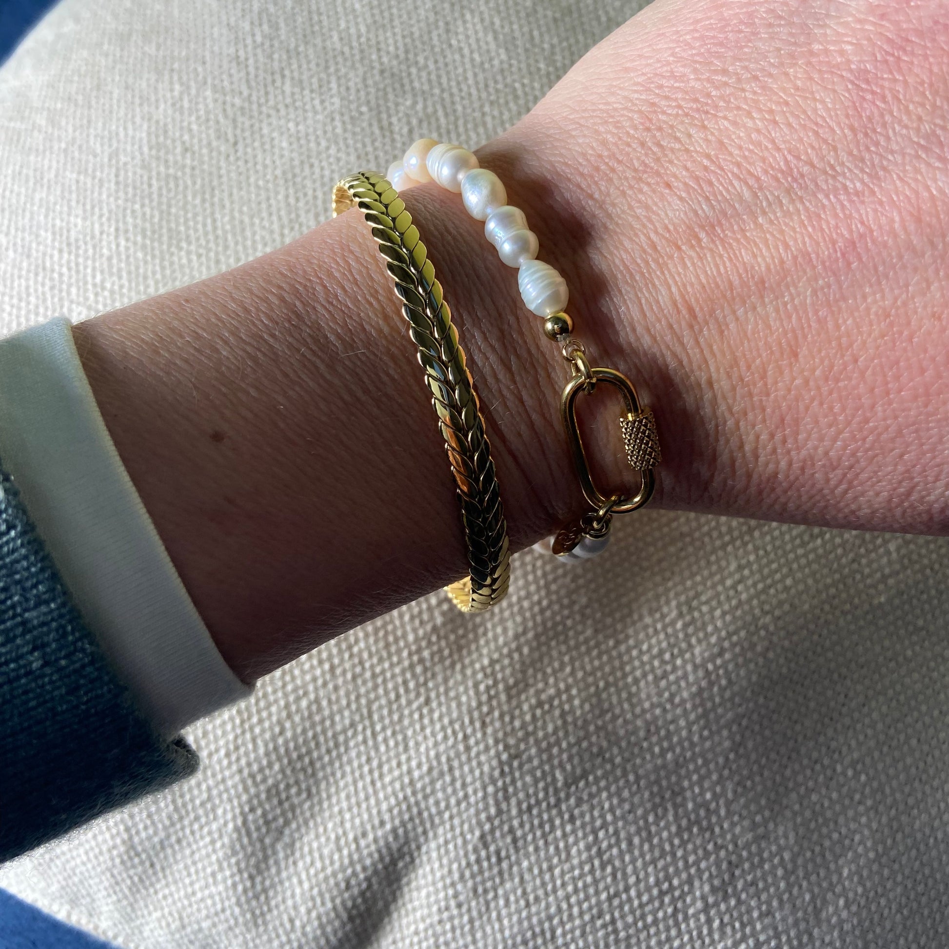 Close-up of the Freshwater Pearl Bracelet showing the oval gold clasp and elastic pearls