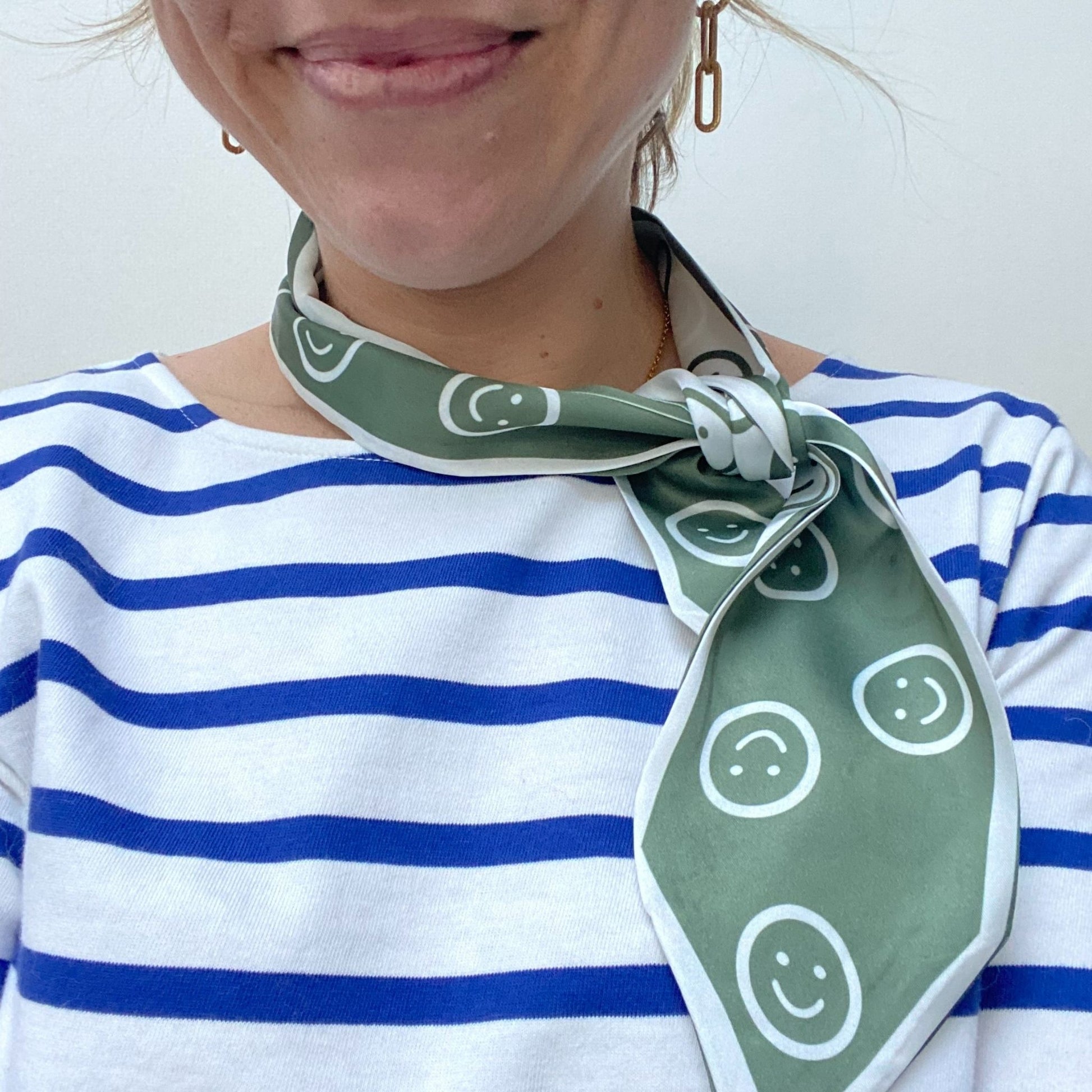 green smiley face scarf on a lady