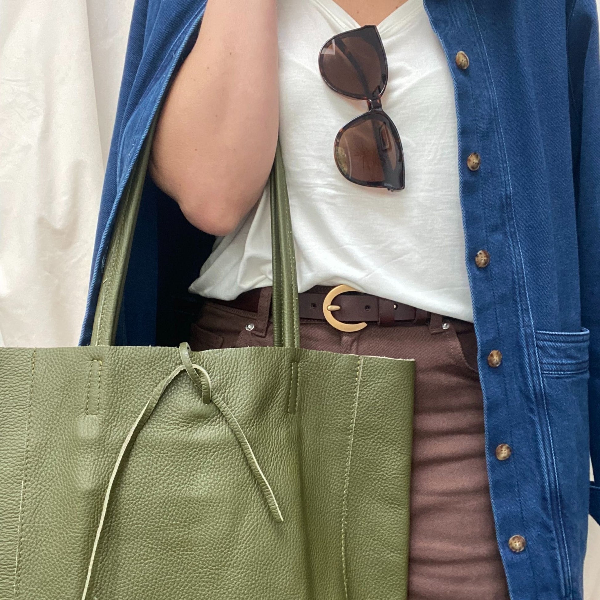 Lady holding green leather bag 