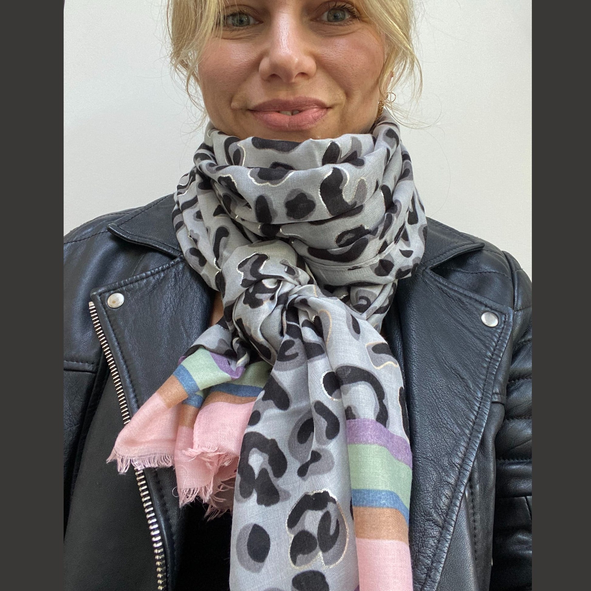 lady wearing leopard print scarf with pastel trim