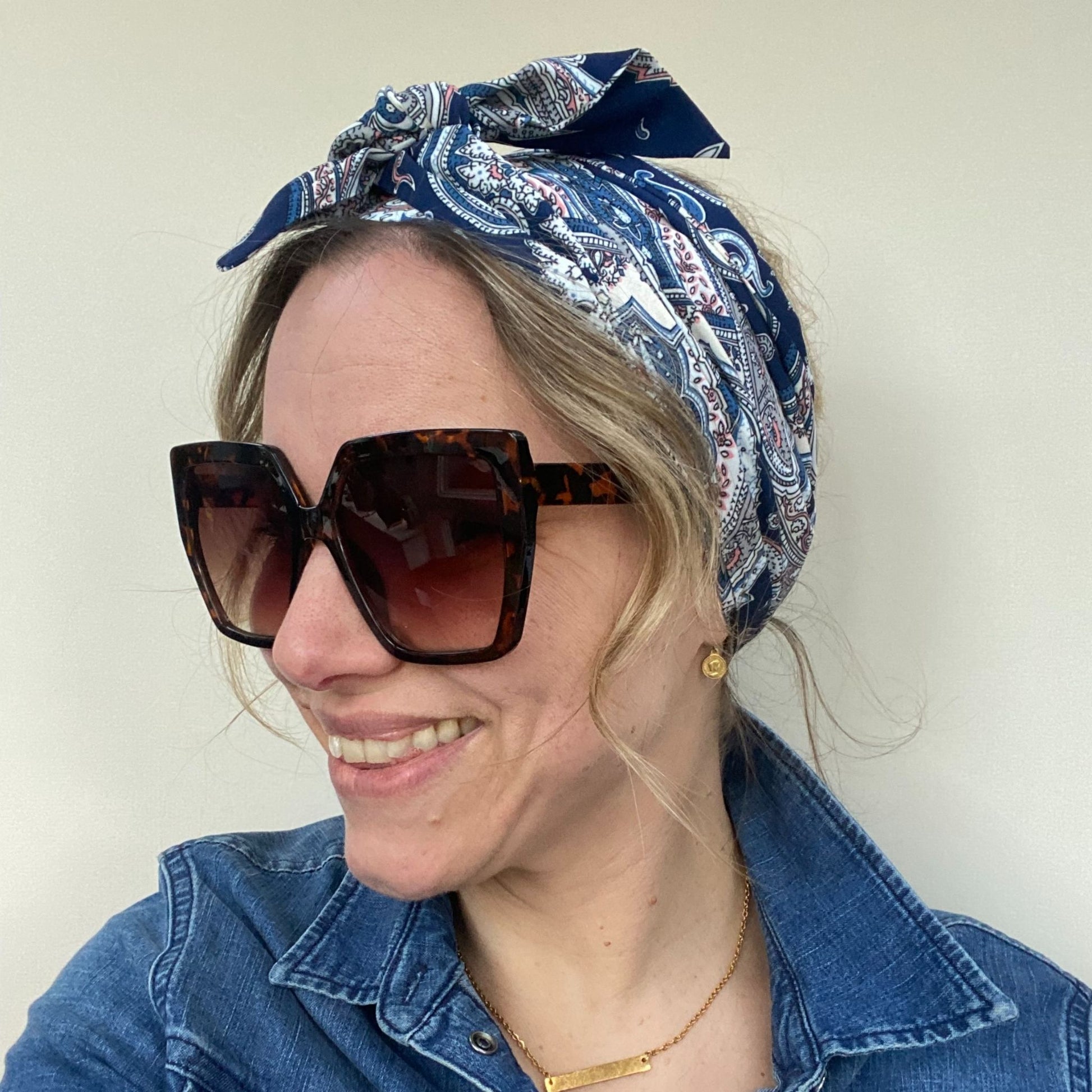 lady wearing paisley headscarf and sunglasses