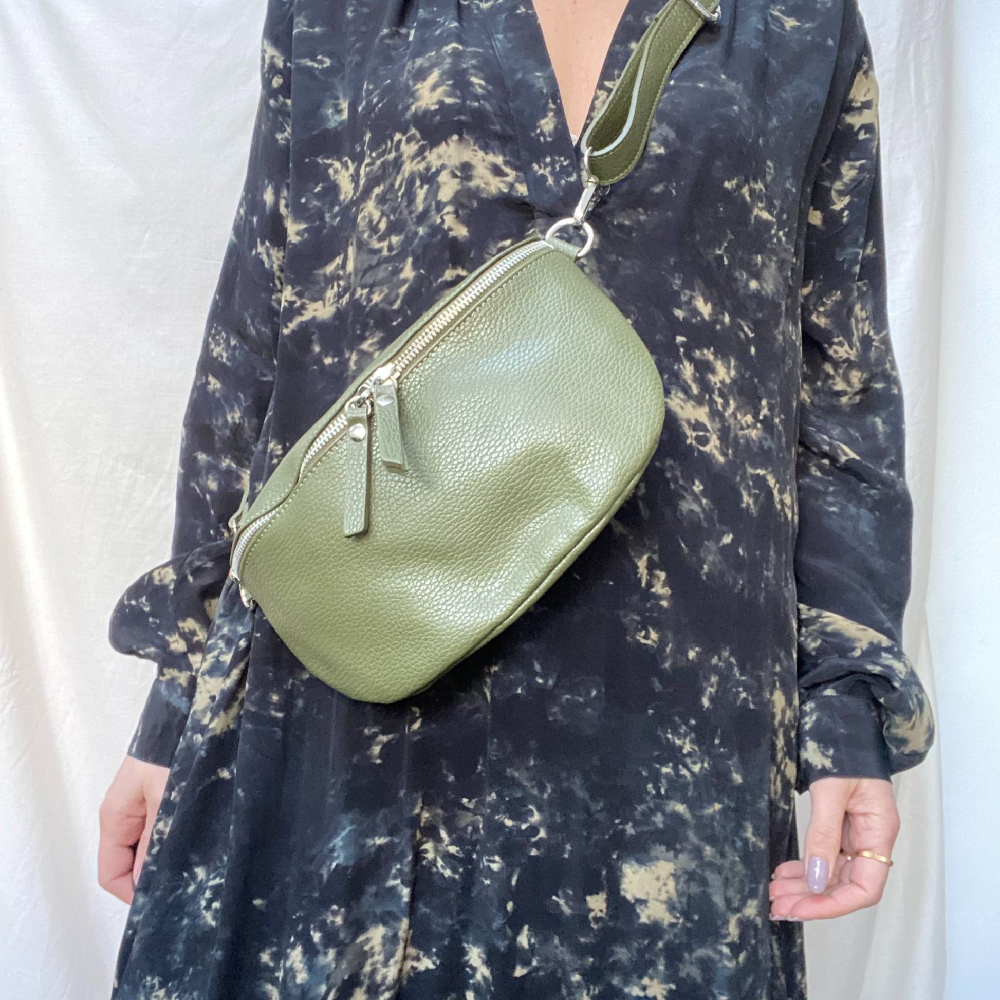 green leather bumbag on woman in dress
