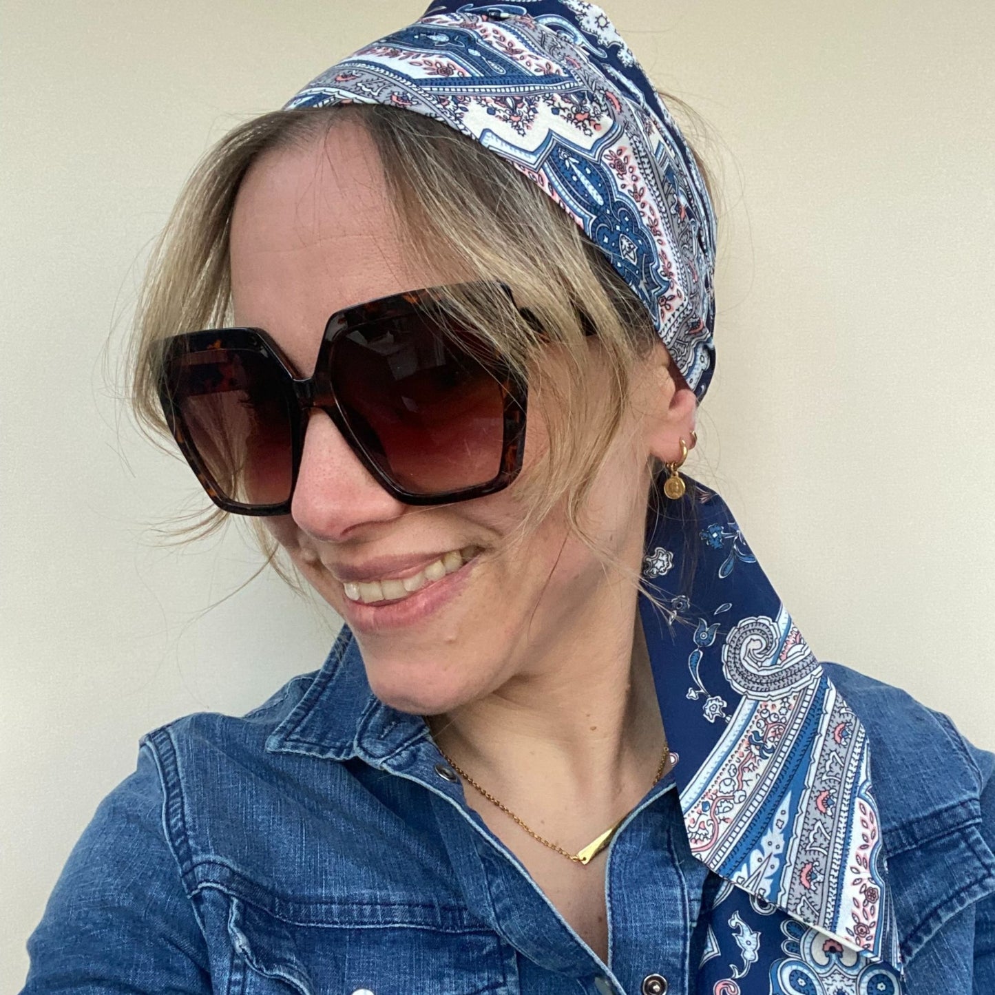 lady wearing paisley headscarf and sunglasses