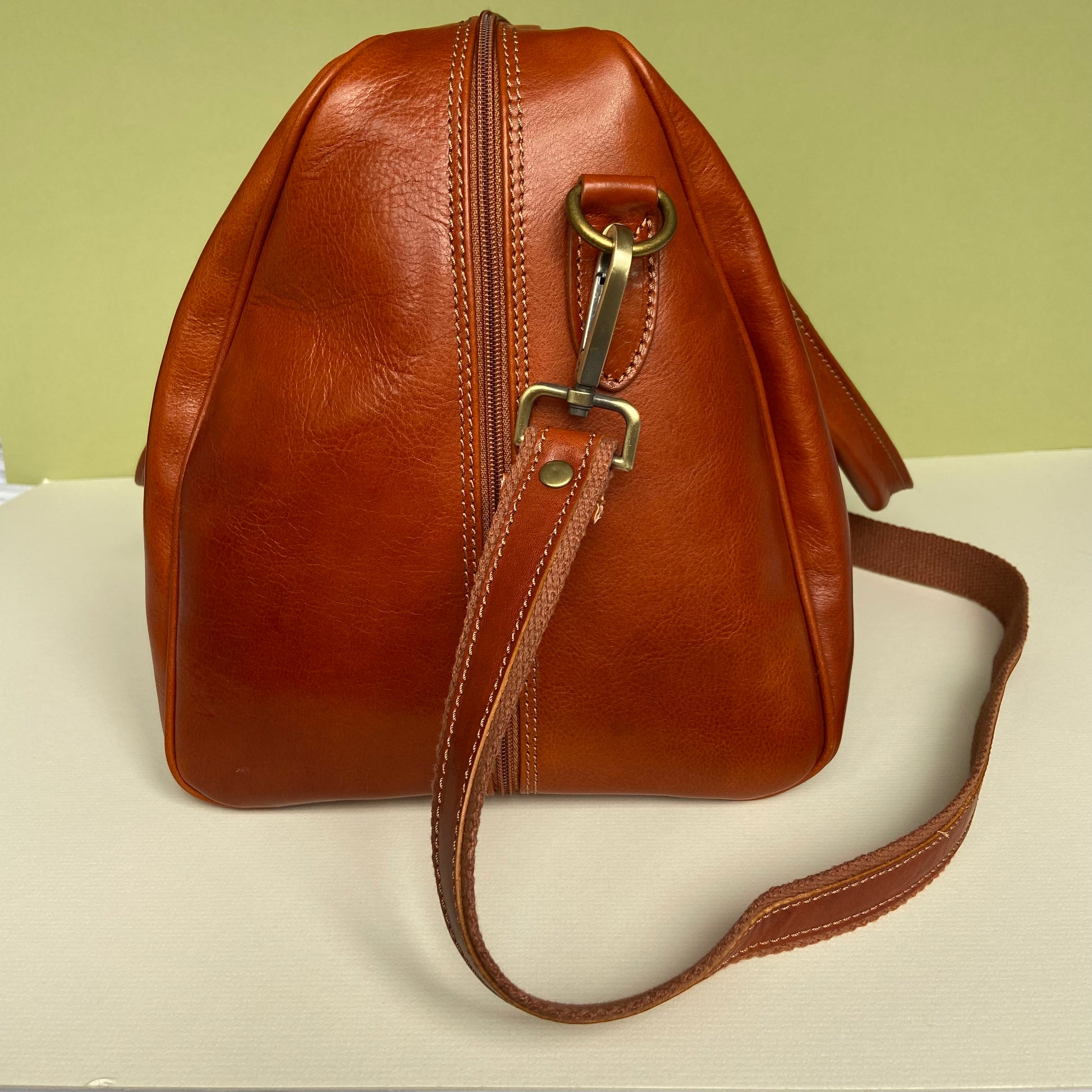 side view of leather holdall with strap